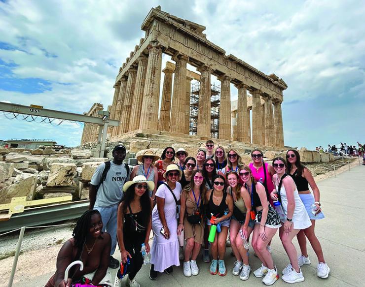 Image of a group of AHS students posing for a photo in front of the Parthenon in Greece