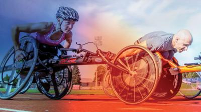 2 wheelchair racers aggresively moving forward