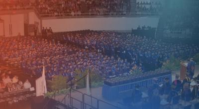 1500 seated students in blue graduation gowns