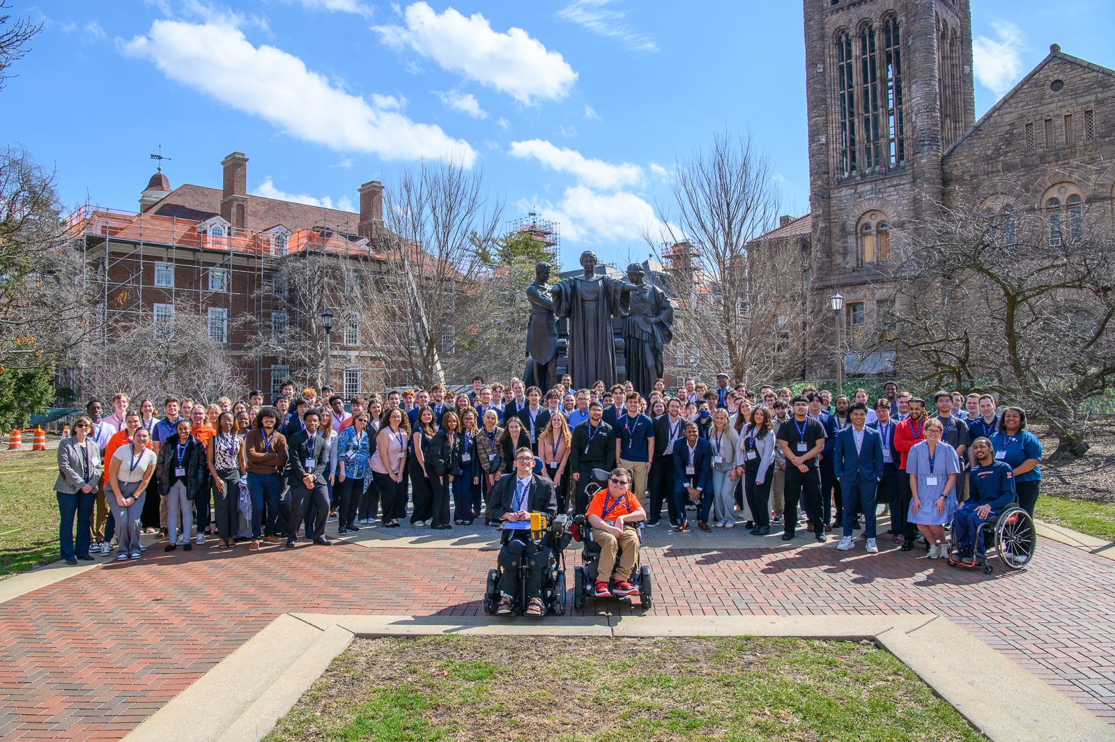 More than one hundred students and visitors at Recreation, Sport and Tourism line up for a picture next to the Alma Mater statue.